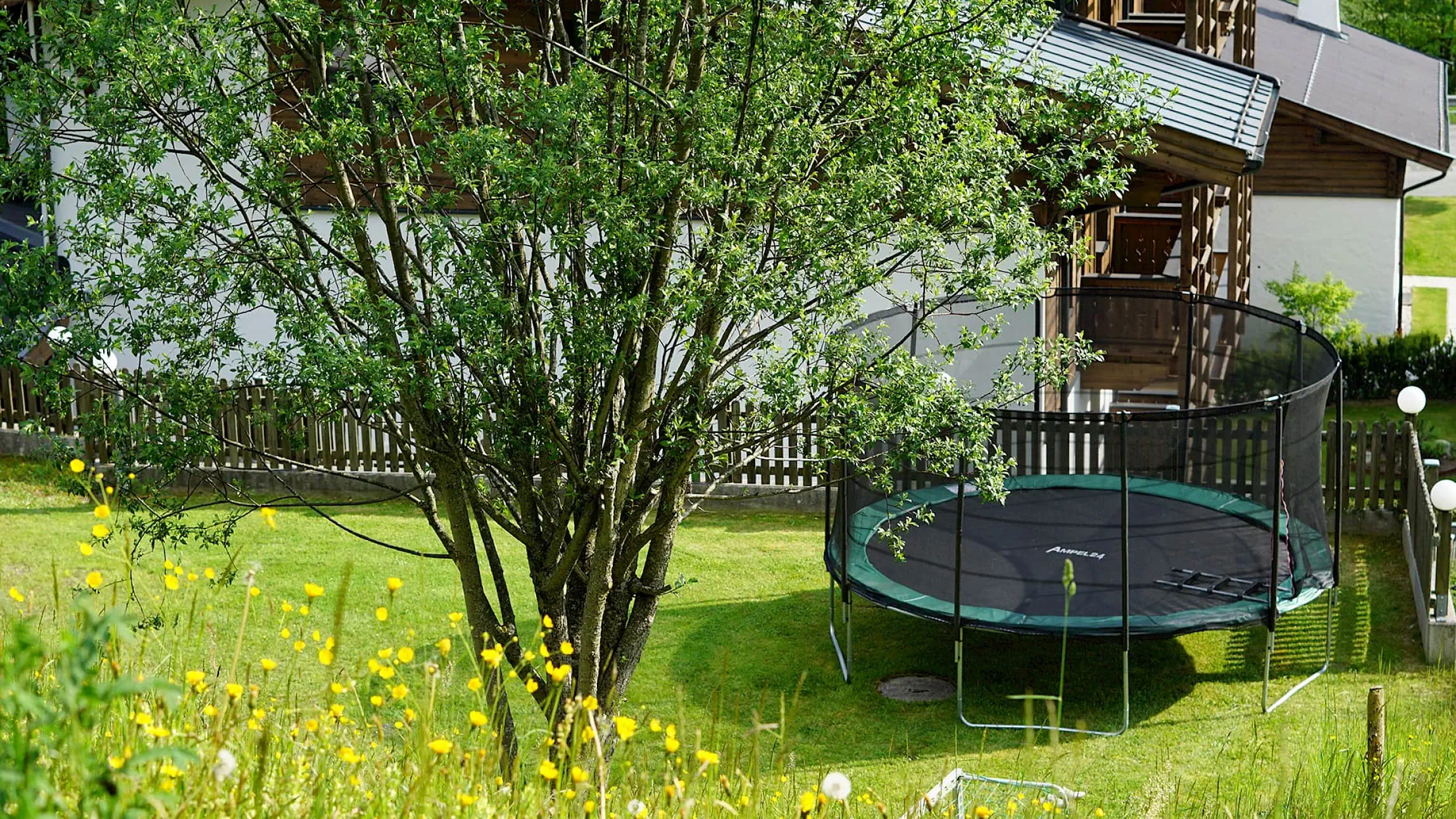Playground with trampoline, meadow all around | Zirmhof Apartments
